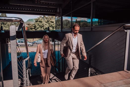 Modern business couple after a long day's work, walking together towards the comfort of their home, embodying the perfect blend of professional success and personal contentment