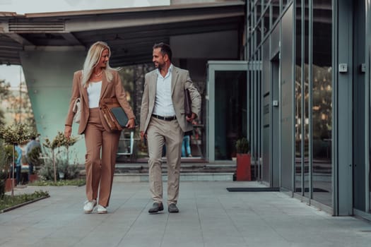 Modern business couple after a long day's work, walking together towards the comfort of their home, embodying the perfect blend of professional success and personal contentment