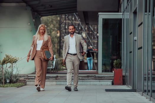 Modern business couple after a long day's work, walking together towards the comfort of their home, embodying the perfect blend of professional success and personal contentment