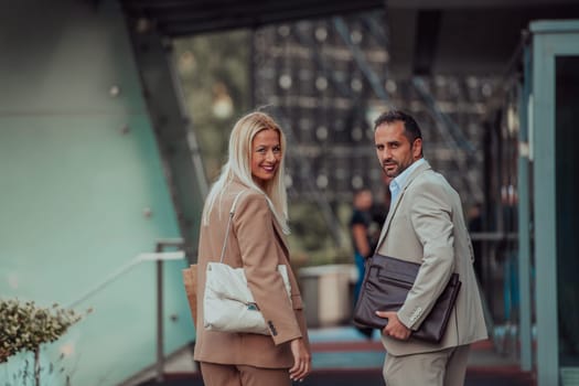 Modern business couple after a long day's work, walking together towards the comfort of their home, embodying the perfect blend of professional success and personal contentment