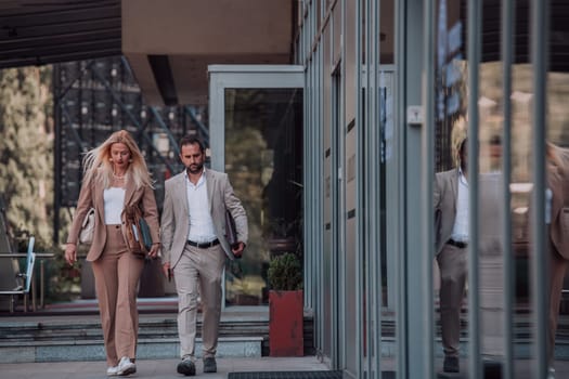 Modern business couple after a long day's work, walking together towards the comfort of their home, embodying the perfect blend of professional success and personal contentment