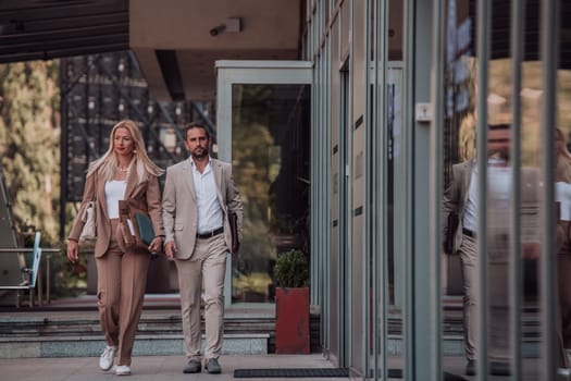 Modern business couple after a long day's work, walking together towards the comfort of their home, embodying the perfect blend of professional success and personal contentment