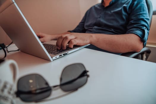 Close-up photo of a programmer typing on a laptop. High quality photo