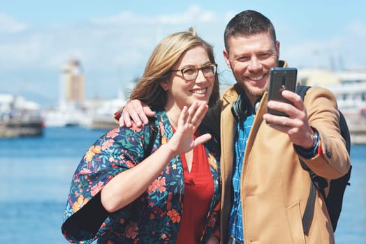 Video call, travel and couple with phone by harbor enjoy vacation, holiday and journey in Amsterdam. Dating, communication and happy man and woman on smartphone for social media, vlog and influencer.