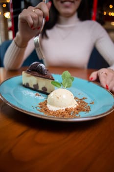 a girl without a face eats dessert in a cafe.