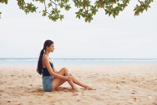 attractive woman sun travel relax sitting beach tan freedom person nature beauty natural vacation pretty body summer smile sea sand outdoor