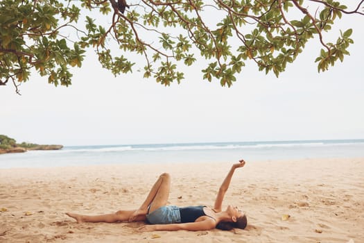 woman sitting female vacation summer natural young attractive sand pretty beauty ocean sea beautiful beach travel smile nature body freedom tan