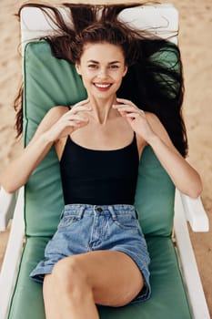 woman sunbed sun resort blue holiday young tropical ocean lying smiling enjoy attractive beach sand exotic caucasian sunglasses chair sea lifestyle