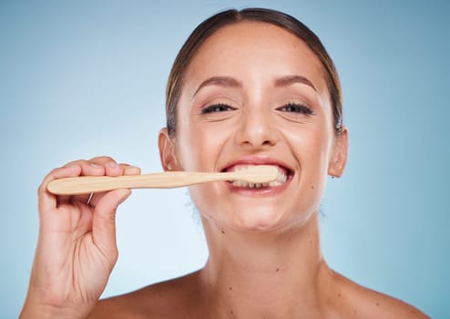 Brushing teeth, dental and woman with toothbrush for teeth whitening and beauty, oral health and fresh breath with studio background. Mouth wellness, Invisalign portrait and clean with bamboo brush