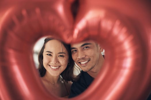 Valentines day heart, balloon and young couple portrait celebrate love, happiness and care. Red balloons, present and romance of a happy Asian woman and man from Peru together with a smile on a date.