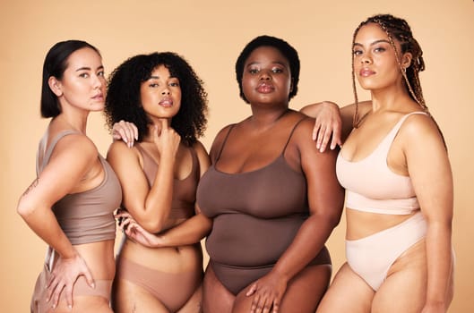 Body positive, diversity and portrait of women group together for inclusion, beauty and power. Underwear model people or friends on beige background for skincare, pride and motivation for self love.