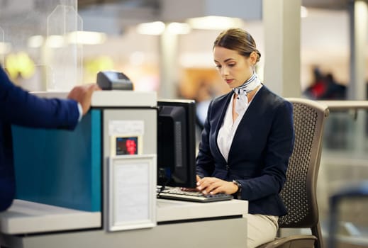 Airport, check in desk and woman typing for security, identity and travel documents for border immigration service. Concierge, customer service and help for global transportation with pc on table.