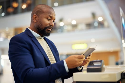 Black man, reading passport and airport for travel, security and identity for global transportation service. African businessman, documents and concierge for immigration with international transport.