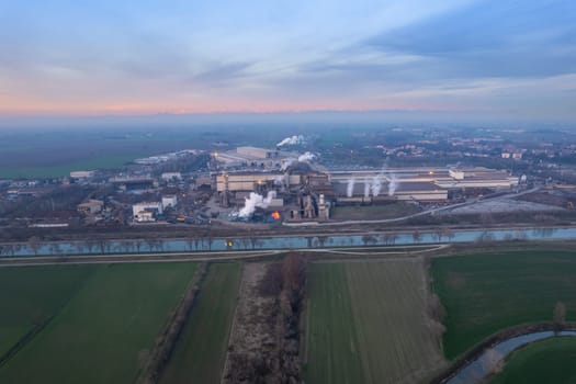Cremona, Italy - January 2022 Drone aerial view of Arvedi working steel plant at dawn, industrial zone in Spinadesco, Cremona, Lombardy Italy
