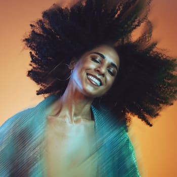 Hair movement, beauty and face of black woman with afro in studio for hair care, beauty products and wellness. Creative art, hair salon and happy female with motion for cosmetics, fashion and makeup.