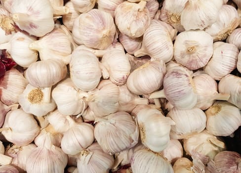 close-up of a garlic background in a vegetable market, lots of garlic heads.