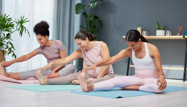 Pregnant, stretching and yoga by women on a floor for exercise, fitness and workout in a home together. Friends, pregnancy and group stretch, workout and pilates in a living room, training and cardio.
