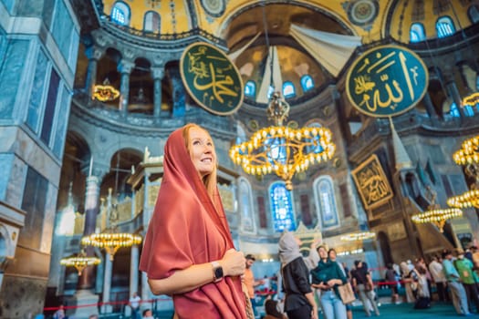 INSCRIPTION - denoting the names of Allah, the Prophet Muhammad, as well as the first 4 caliphs Woman tourist enjoying Hagia Sofia, Ayasofya interior in Istanbul, Turkey, Byzantine architecture, city landmark and architectural world wonder. Turkiye.