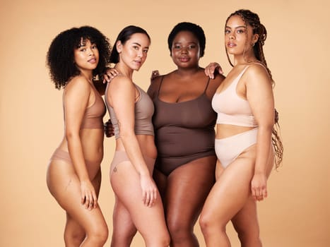 Body, skin and diversity women portrait of group together for inclusion, beauty and power. Underwear model friends hug on beige background with skincare, color pride and motivation for self love.