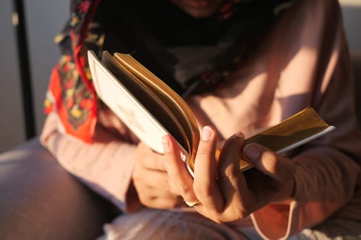 Muslim women's hand reading quran at night .