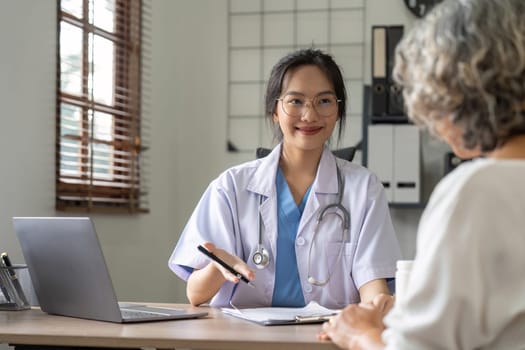 Doctor or physician writing diagnosis and giving a medical prescription to male Patient.