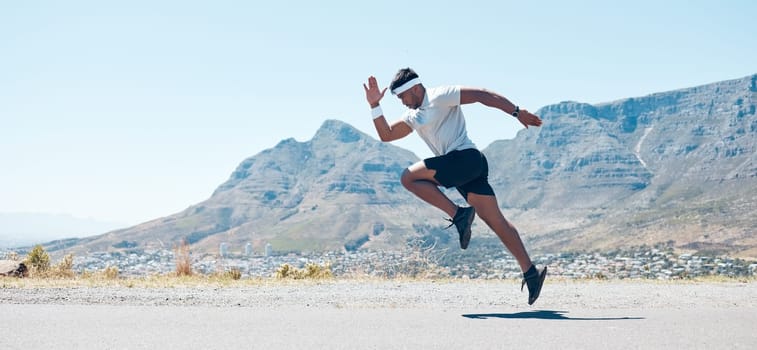 Man, fitness and mountain running on road for cardio workout, training or exercise banner in nature. Fit, active or sport male person, athlete or runner exercising on asphalt street with mockup space.