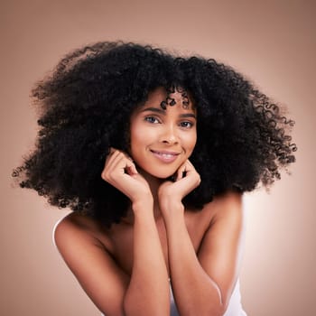 Hair, afro and portrait of black woman with smile on brown background for wellness, shine and natural glow. Salon, luxury beauty and happy girl face with curly hairstyle, texture and growth treatment.