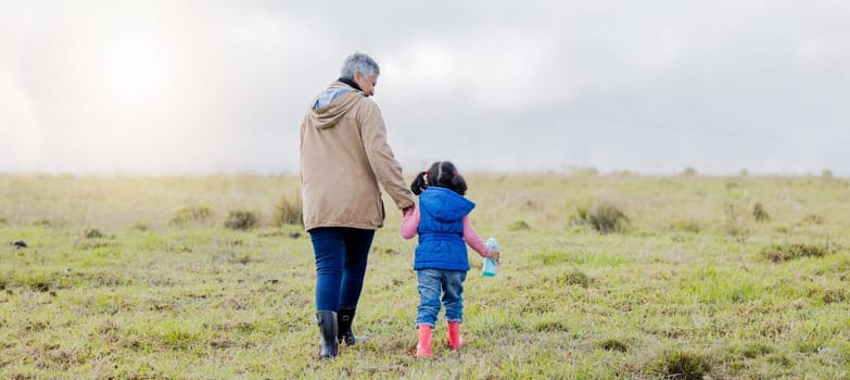 Back, love and grandmother with girl, countryside and bonding together, happiness and loving. Family, granny and granddaughter in nature, morning and walking for fresh air, balance and affection.