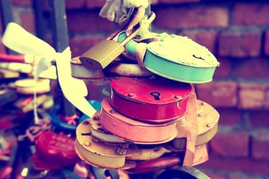 Lots of old love padlocks close up. Toned image