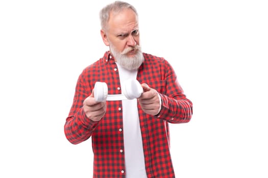 middle age business. handsome mature gray-haired man with a beard and headphones.