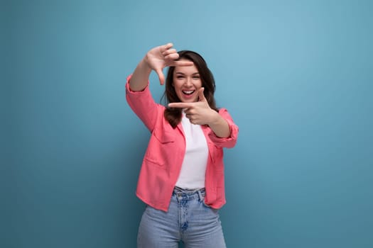 cheerful brunette young female adult in a shirt with joyful emotions on an isolated background.