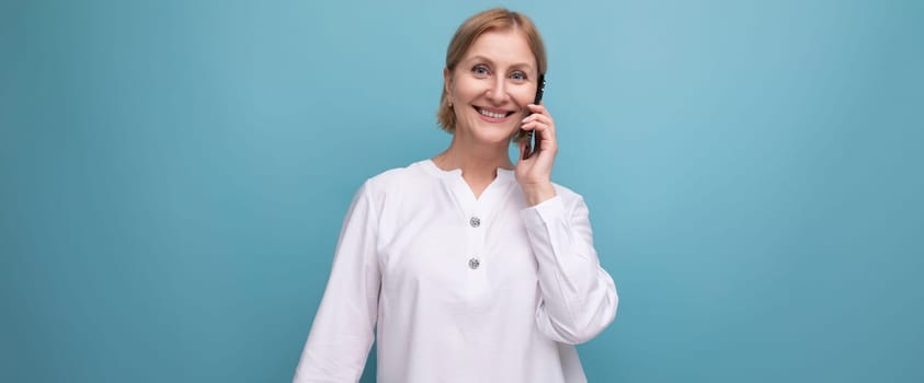 happy blond middle aged woman in white blouse.
