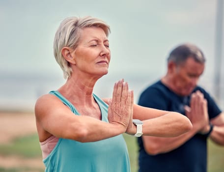 Yoga, fitness and senior woman in praying hands for spiritual wellness, holistic meditation or retirement health. Calm mind, prayer and elderly couple or personal trainer meditate, namaste and peace.