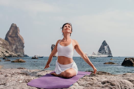 Fitness woman sea. Outdoor workout on yoga mat in park near to ocean beach. Female fitness pilates yoga routine concept. Healthy lifestyle. Happy fit woman exercising with rubber band in park.