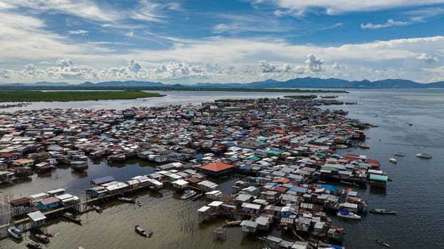 Aerial view of fishing village located on the water in the sea. Houses of the poor. Borneo,Semporna. Sabah, Malaysia.