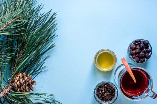 Mulled wine with spices on blue background. Top view. Still life. Copy space. Flat lay