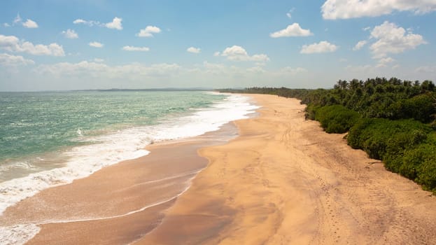 Seascape with tropical sandy beach and blue ocean. Sri Lanka.