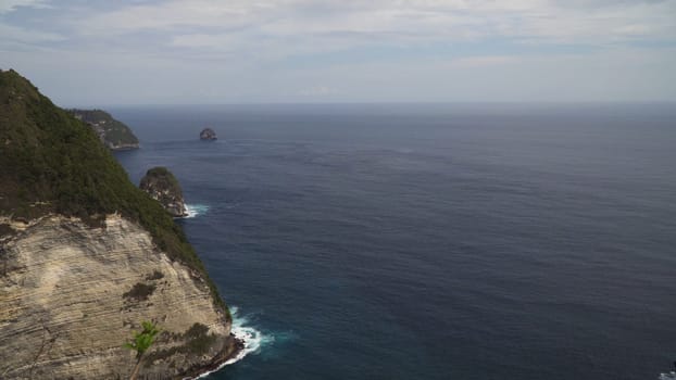 Seascape, rocky coast, ocean, blue sea, waves, Nusa Penida, Indonesia. Ocean with waves and rocky cliff Travel concept