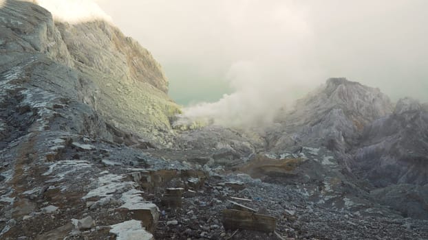 Extraction of sulfur in the crater of a volcano. Sulfur gas, smoke. Kawah Ijen, crater with acidic crater lake where sulfur is mined. Ijen volcano complex is a group of stratovolcanoes in the Banyuwangi Regency of East Java, Indonesia.