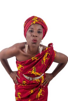 Beautiful african woman wearing traditional clothes, looking at camera and smiling, making a kiss isolated on white background
