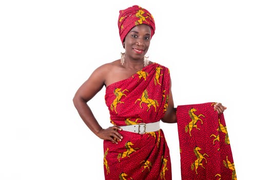 fashionable woman in red traditional dress, looks and presents an African stuff