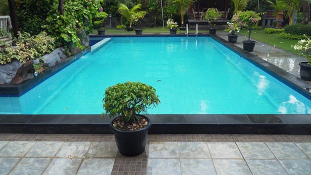 Luxurious open air swimming pool at resort. Swimming pool with turquoise water in a luxury hotel. Travel concept.