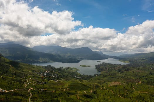 Aerial view of lake in a mountainous area among tea plantations. Maskeliya, Castlereigh, Sri Lanka.