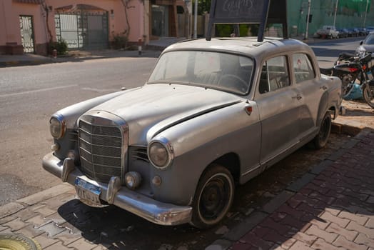 Old silver wedding car parking in the street. High quality photo