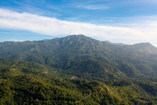 Aerial drone of mountains covered with forest and jungle in the morning haze. Sri Lanka.