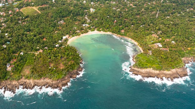 A Hiriketiya beach in a lagoon among palm trees. Sri Lanka.