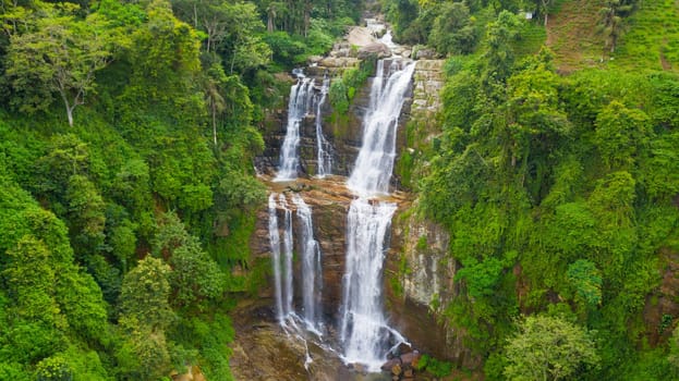 Waterfall in a tropical forest. Aerial view of Lower Ramboda Falls. Sri Lanka.