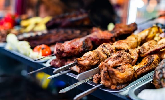 Barbecue grill meat at street food market. Fresh cooking delicious bbq beef at traditional fair