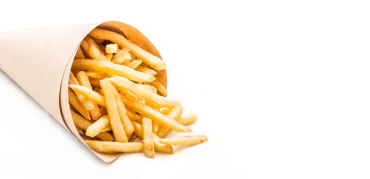 Fresh french fries chips wrapped in brown craft paper on a white background