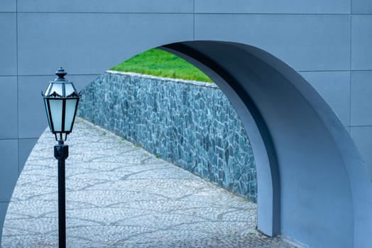 Street lantern on the background of the arch of the bridge.